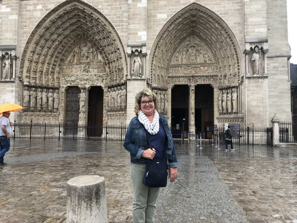 Ornate sculpted portals of Notre-Dame Cathedral showcasing detailed Gothic carvings on the west façade